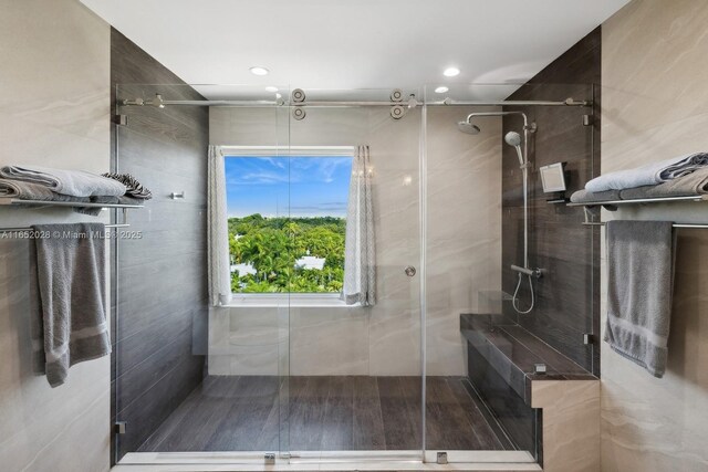 bathroom featuring a shower with door