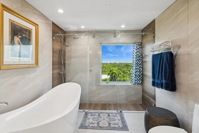 bathroom with plus walk in shower and tile walls