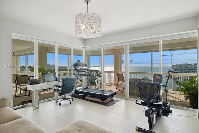 workout room featuring an inviting chandelier