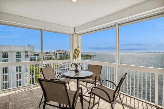 sunroom / solarium with a water view