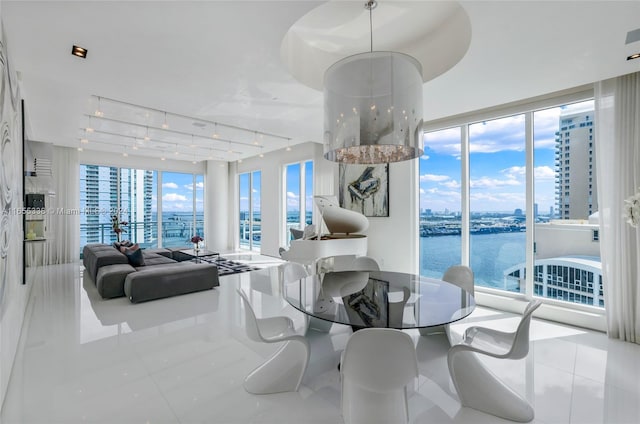 tiled dining area with plenty of natural light and a water view