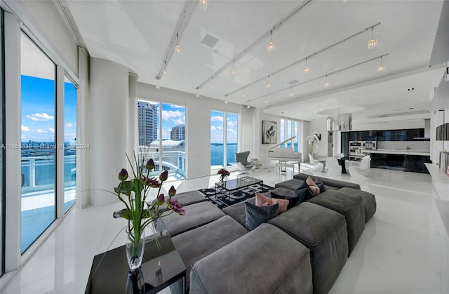 tiled living room featuring a water view