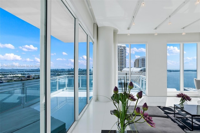 interior space featuring a water view and track lighting