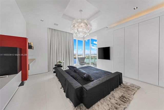 tiled bedroom featuring a raised ceiling and a notable chandelier