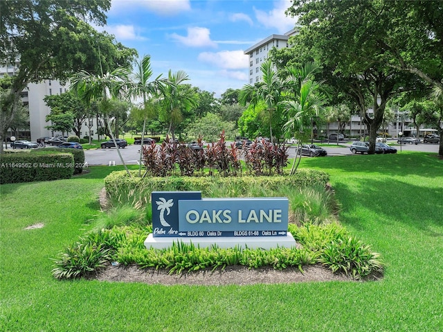 community / neighborhood sign with a lawn