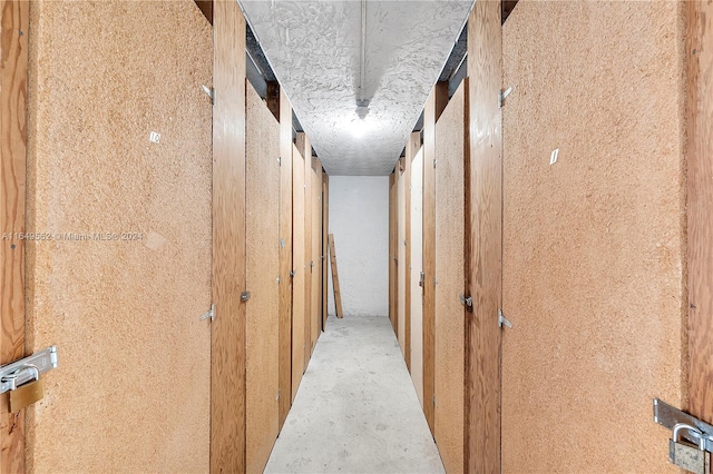 hall featuring a textured ceiling