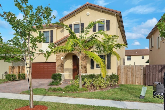 23841 SW 118th Pl, Homestead, FL 33032 - mediterranean / spanish house with fence, an attached garage, stucco siding, a tiled roof, and decorative driveway