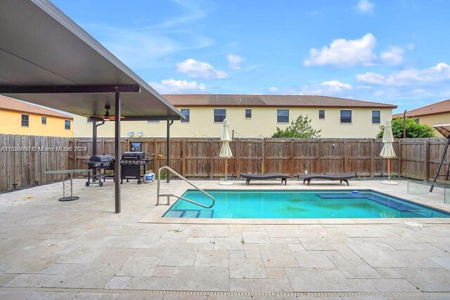 23841 SW 118th Pl, Homestead, FL 33032 - view of pool featuring a fenced in pool, a grill, a fenced backyard, and a patio area