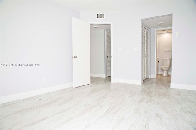 interior space with ensuite bathroom and a closet