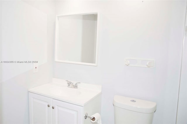 bathroom featuring toilet and vanity