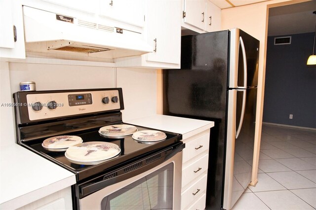 kitchen featuring light tile patterned floors, appliances with stainless steel finishes, and white cabinetry