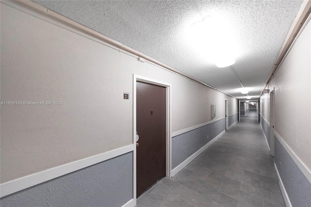 hallway featuring a textured ceiling