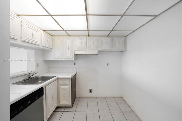 kitchen featuring tile counters, dishwasher, sink, and white cabinets