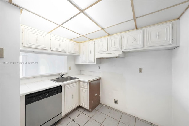 kitchen featuring dishwasher, tile countertops, sink, and white cabinetry