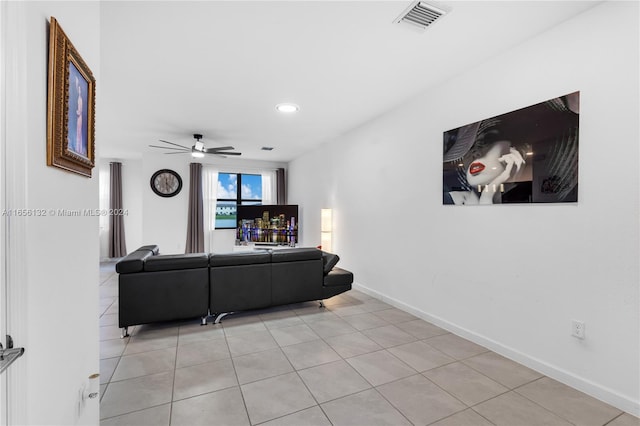 living room with ceiling fan and light tile patterned flooring