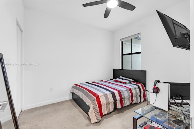 bedroom featuring light carpet and ceiling fan