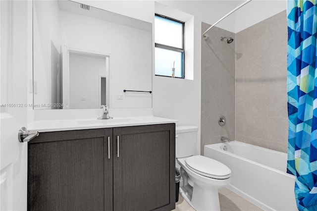 full bathroom featuring vanity, toilet, tile patterned floors, and shower / bath combo with shower curtain