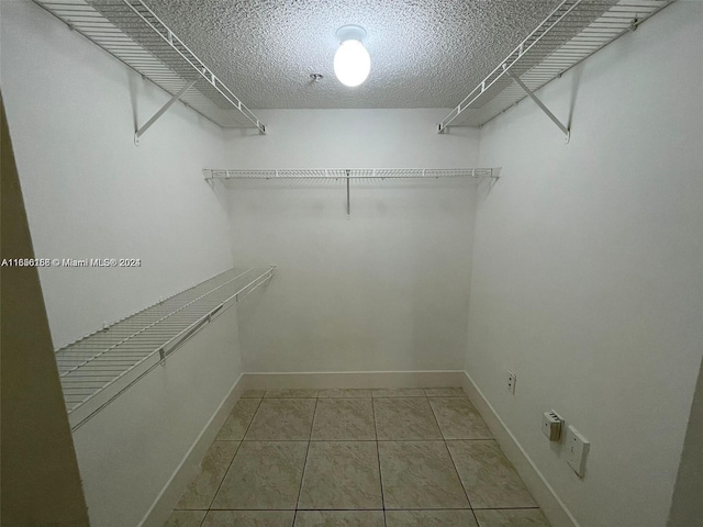 spacious closet with tile patterned floors