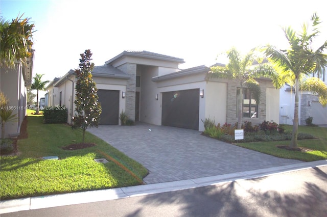 view of front facade with a garage and a front lawn