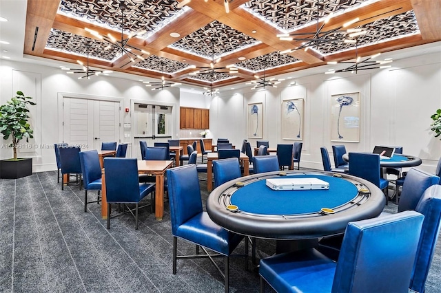 game room with ceiling fan, coffered ceiling, and dark colored carpet