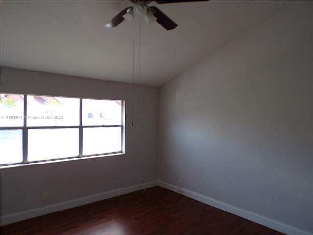 unfurnished room with ceiling fan and dark hardwood / wood-style flooring