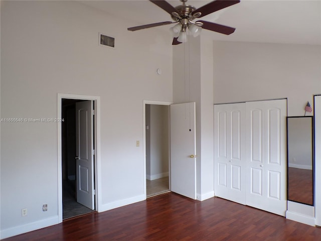 unfurnished bedroom with ceiling fan, high vaulted ceiling, a closet, ensuite bathroom, and dark hardwood / wood-style flooring