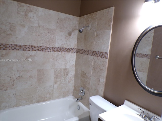 full bathroom with vanity, toilet, and tiled shower / bath