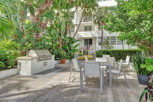 wooden deck with grilling area and an outdoor kitchen