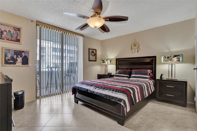 tiled bedroom featuring a textured ceiling, ceiling fan, and access to outside