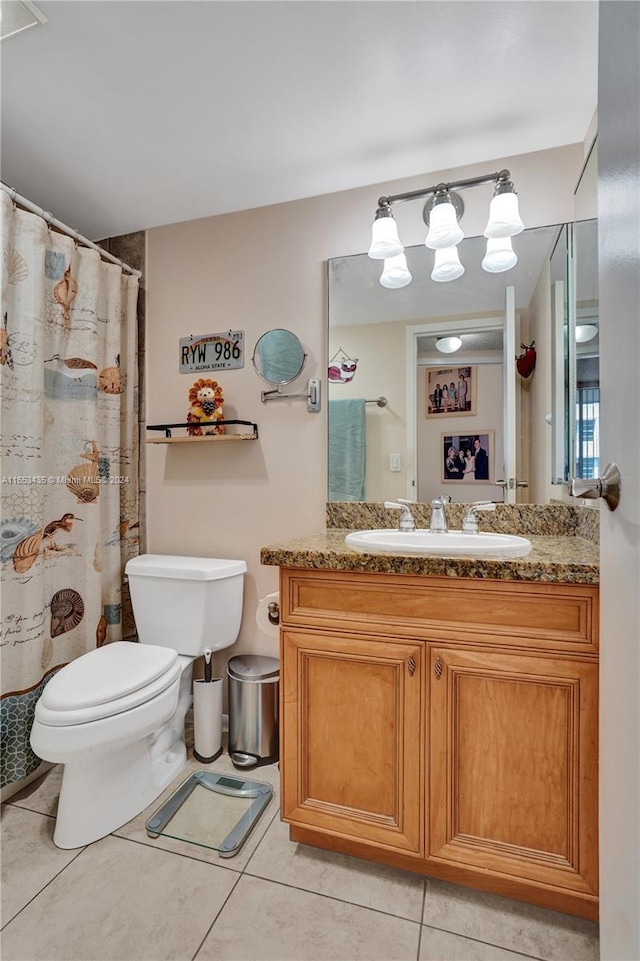 bathroom with vanity, toilet, and tile patterned floors