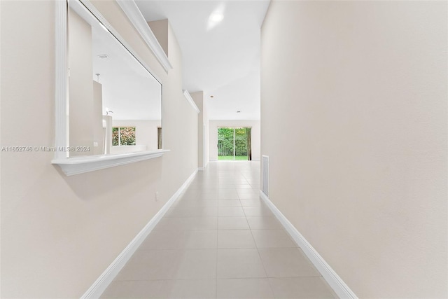 hall with a wealth of natural light and light tile patterned flooring