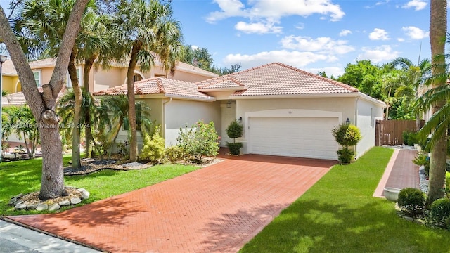 mediterranean / spanish-style house with a garage and a front lawn