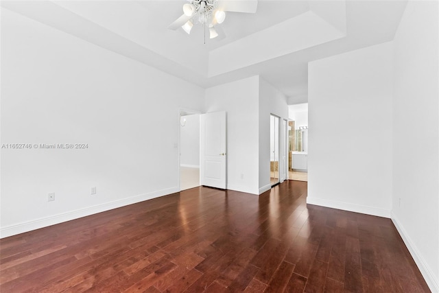 empty room with dark hardwood / wood-style flooring and ceiling fan