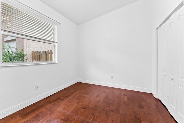 spare room featuring dark hardwood / wood-style flooring