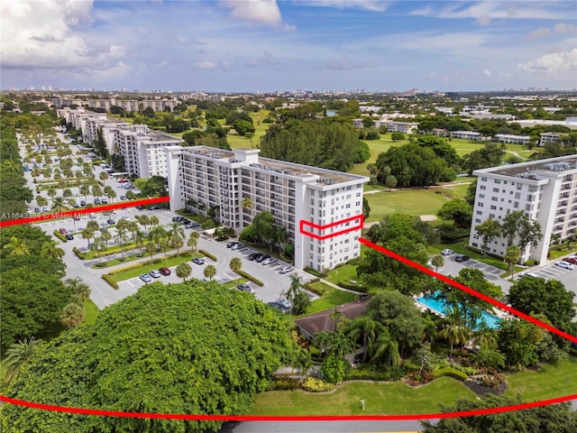 birds eye view of property with a view of city and golf course view