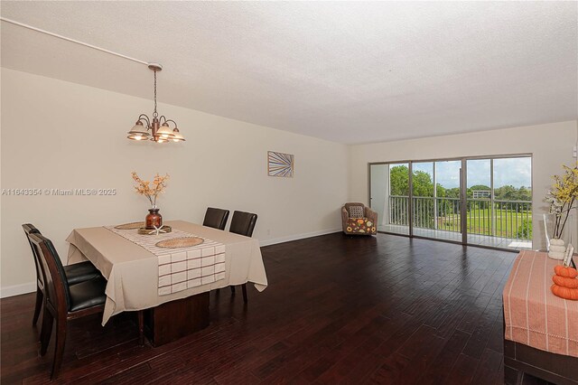 dining space with dark hardwood / wood-style flooring, a chandelier, and a textured ceiling