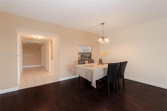3200 N Palm Aire Dr Unit 501, Pompano Beach, FL 33069 - dining space featuring hardwood / wood-style floors, baseboards, and a chandelier