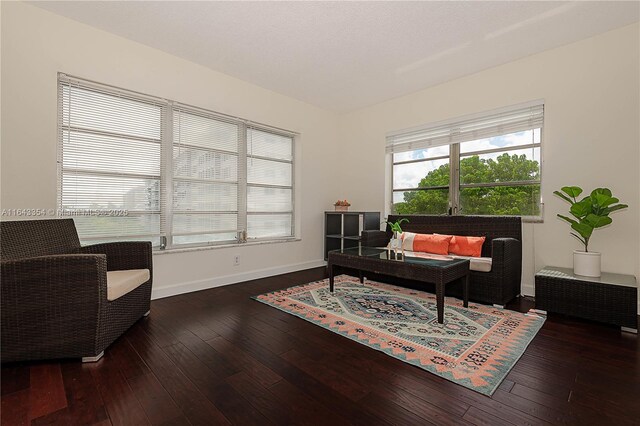 living area with a textured ceiling and dark wood-type flooring