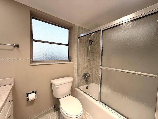 full bathroom featuring toilet, shower / bath combination with glass door, tile patterned flooring, and vanity