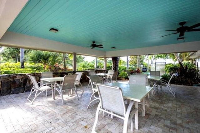 view of patio / terrace featuring ceiling fan, outdoor dining area, and fence