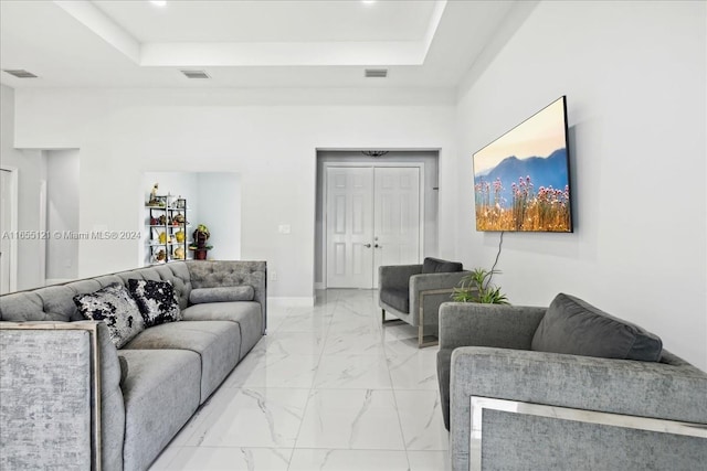 living room featuring a raised ceiling