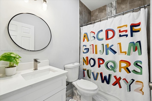 bathroom with vanity, toilet, and walk in shower