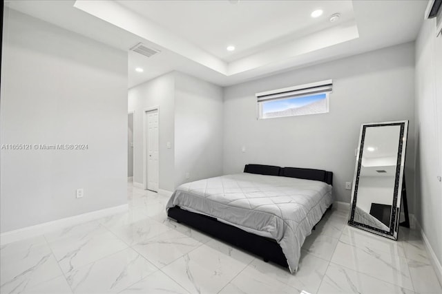 bedroom featuring a raised ceiling