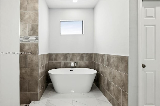 bathroom with tile walls and a bathing tub