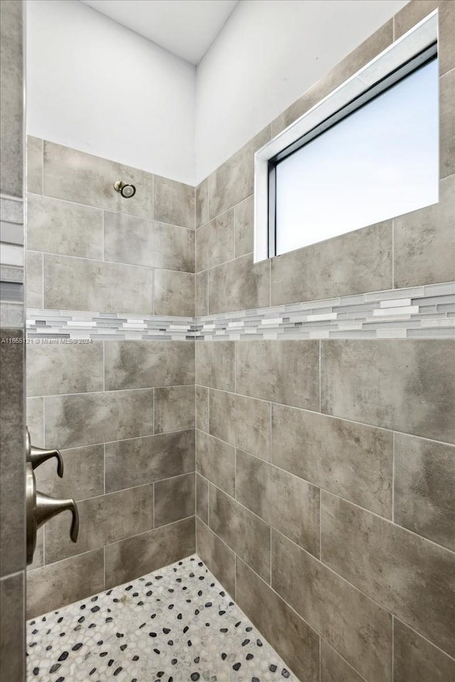 bathroom with a tile shower