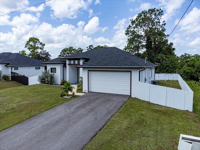 view of front of home with a garage and a front lawn