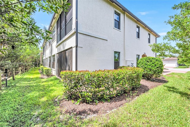 view of side of home with a lawn