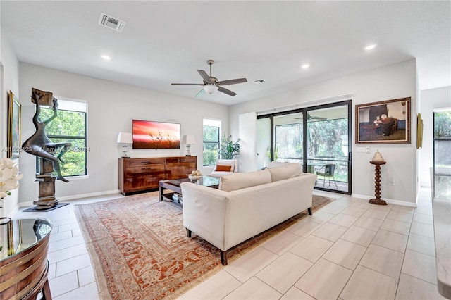 living room with ceiling fan and a healthy amount of sunlight