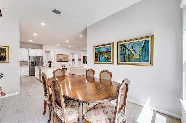 dining room with sink and light tile patterned floors