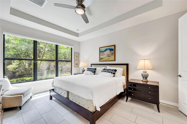 bedroom featuring a tray ceiling and ceiling fan